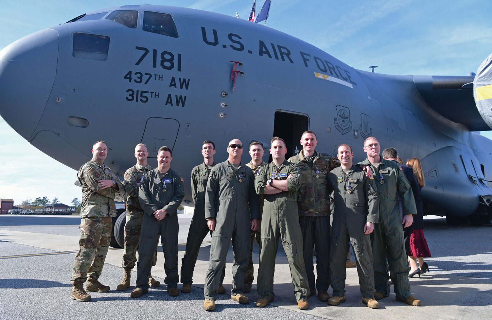 Distinguished Flying Cross (DFC) recipients pose for a photo in front of a C-17 Globemaster III aircraft after receiving their medals from Gen Mike Minihan, Commander of Air Mobility Wing Command, at Joint Base Charleston, SC.