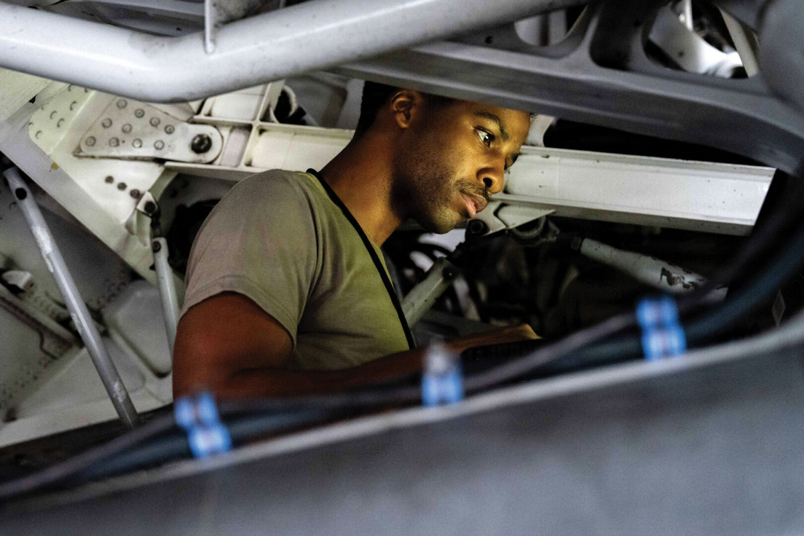 A U.S. Airman assigned to the 15th Maintenance Squadron uses a checklist for maintenance on a wheel well of a C-17 Globemaster III at Joint Base Pearl Harbor-Hickam, Hawaii.