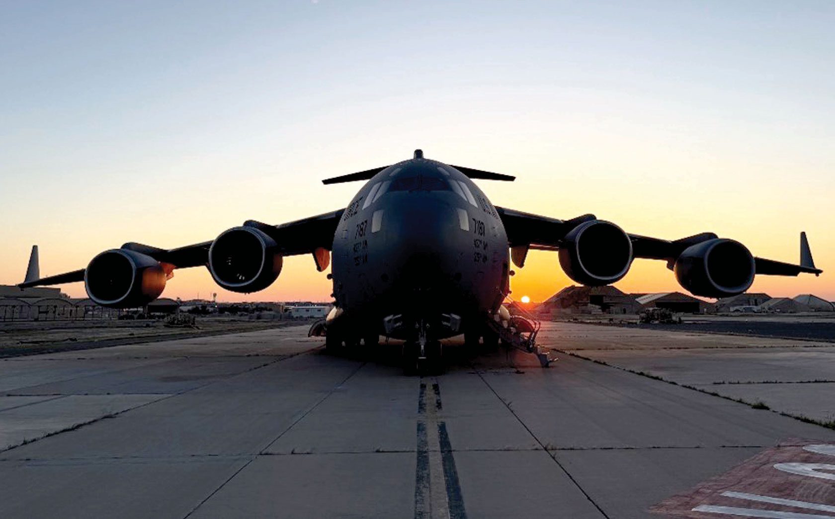 A C-17 Globemaster III aircraft sits on a flightline.