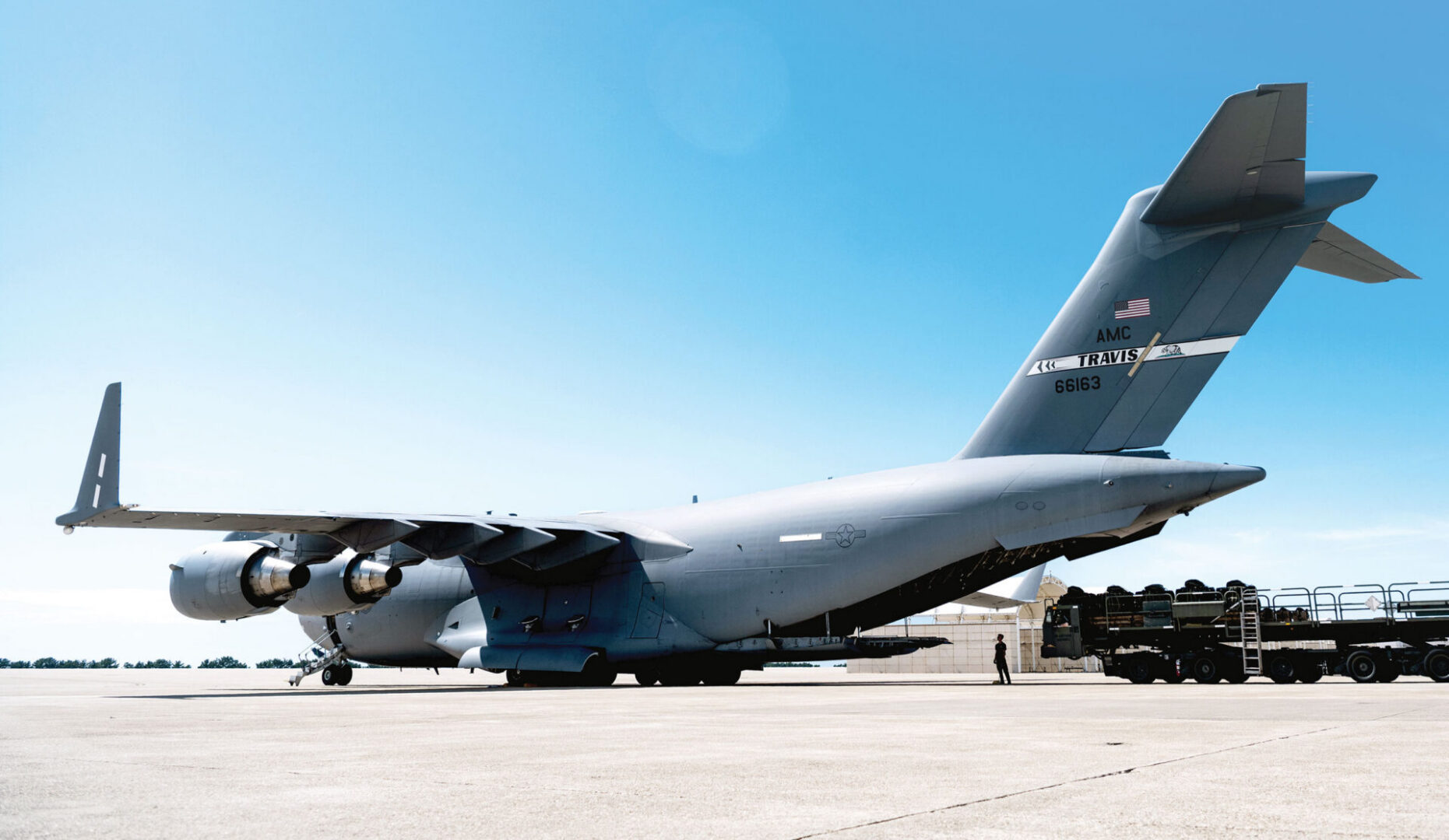 Loadmasters load cargo onto a C-17 Globemaster III aircraft.